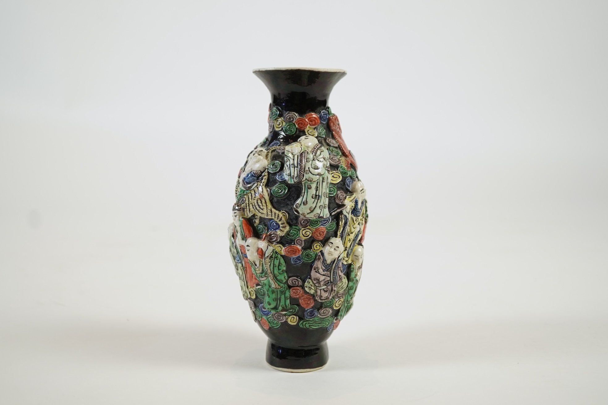 A Chinese enamelled biscuit ‘eighteen Luohan’ vase, 19th century